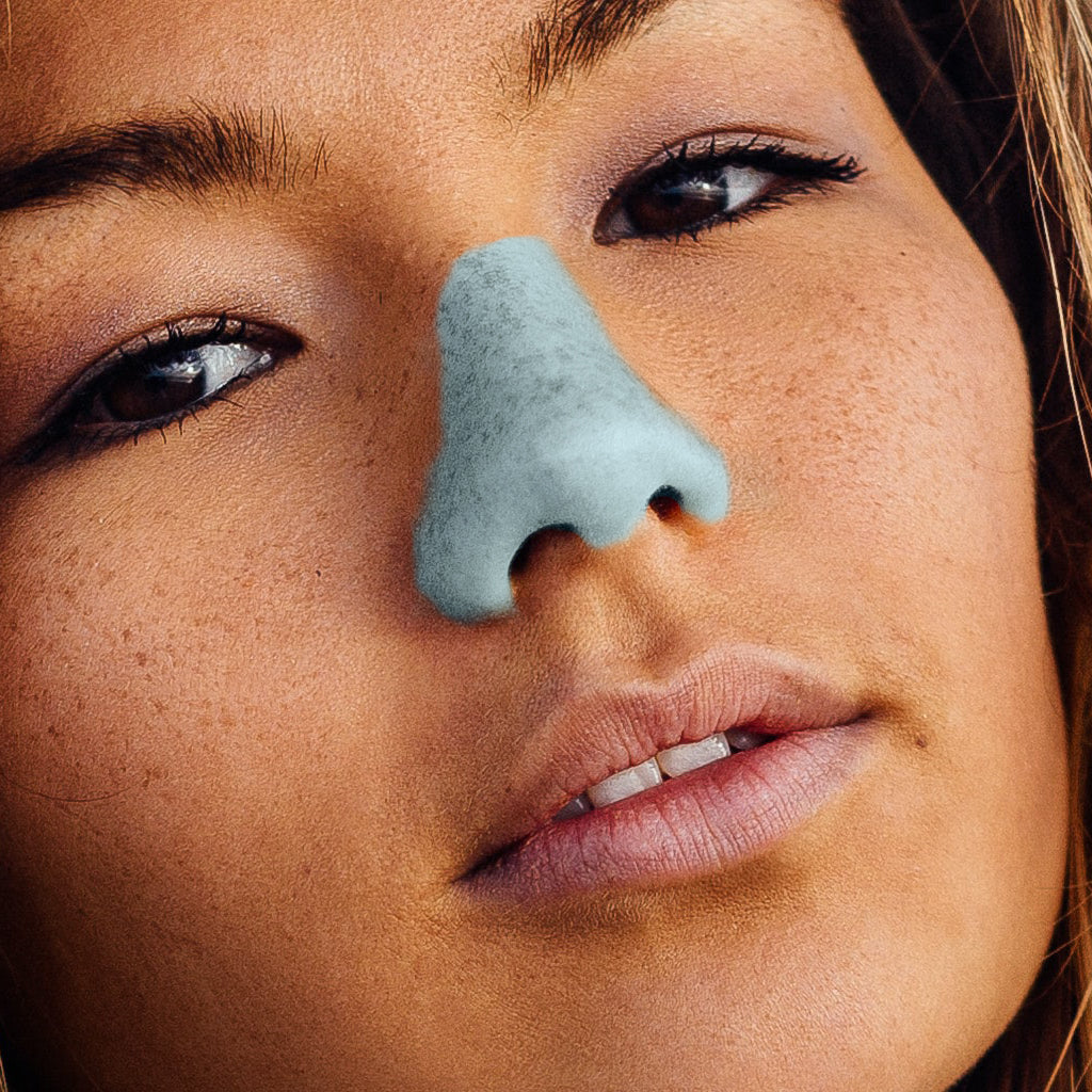 Close up of a girl wearing Electric Blue Noz sunscreen on her nose